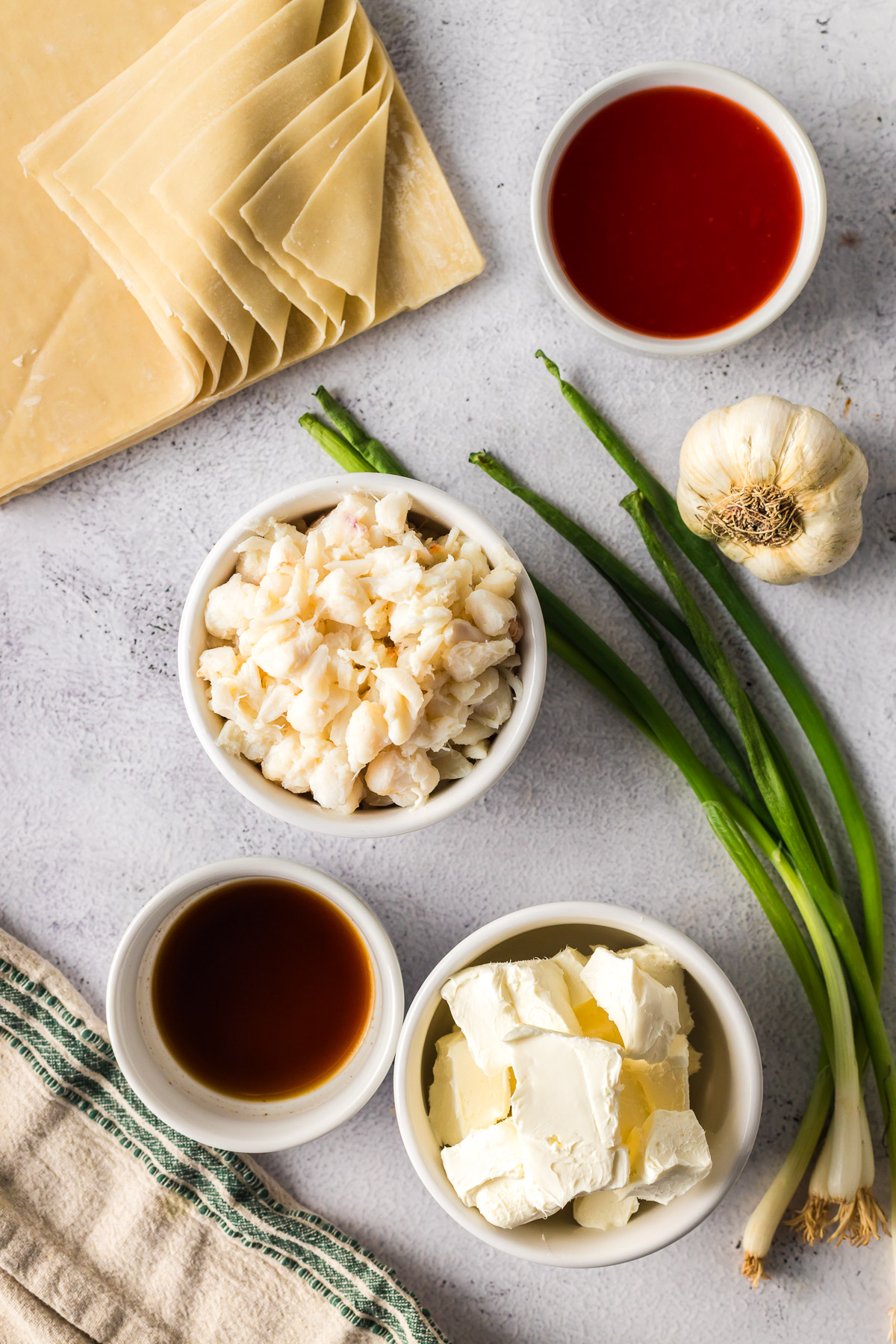 ingredients for crab rangoon, including crab meat, seasonings, and wonton wrappers