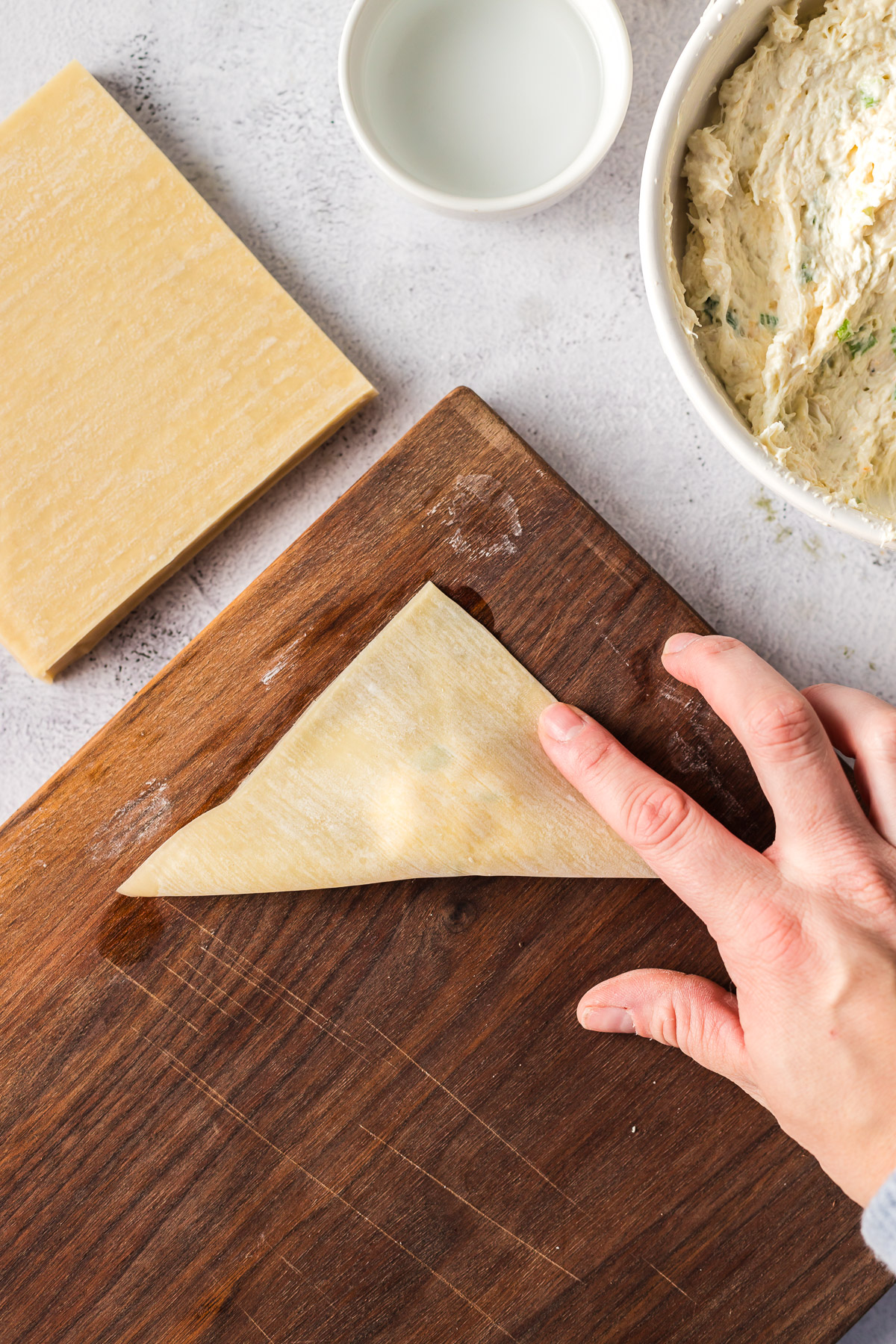 sealing wonton wrapper with fingers 