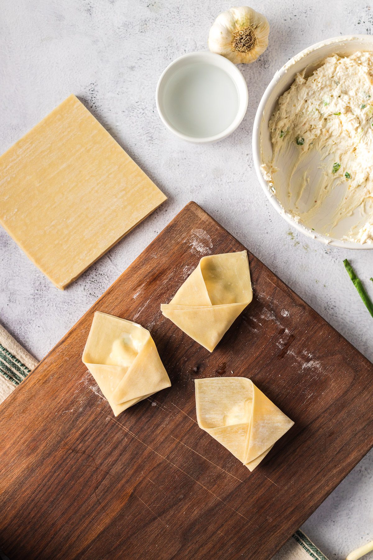 uncooked rangoon on cutting board