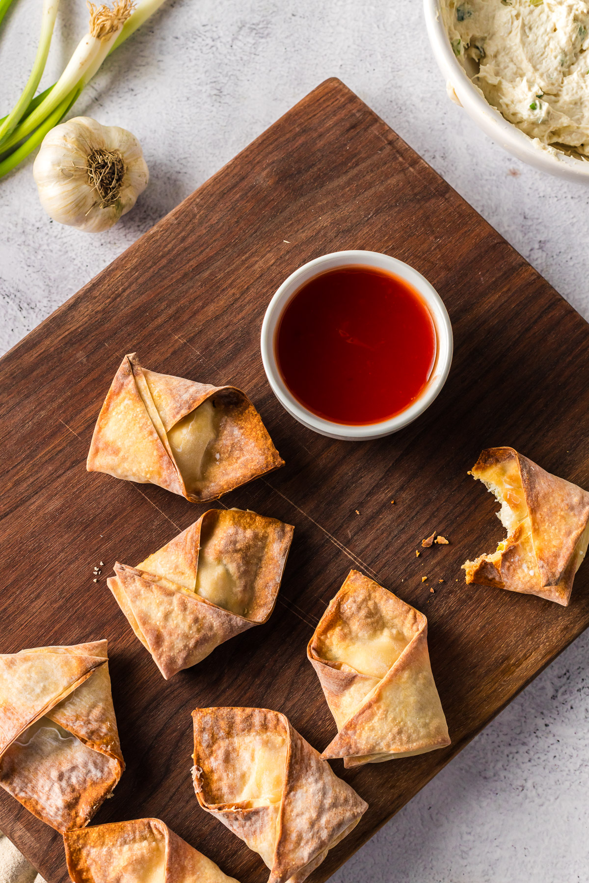 crab rangoon with bit out of side with sweet and sour sauce