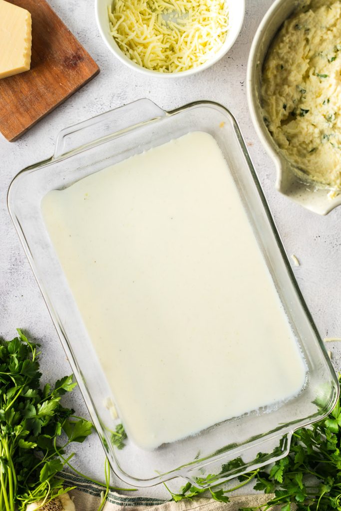 layer of white cheese sauce in bottom of casserole dish