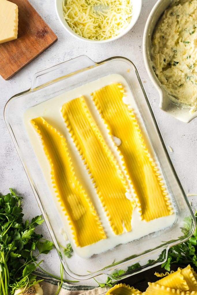 adding lasagna noodles to casserole dish