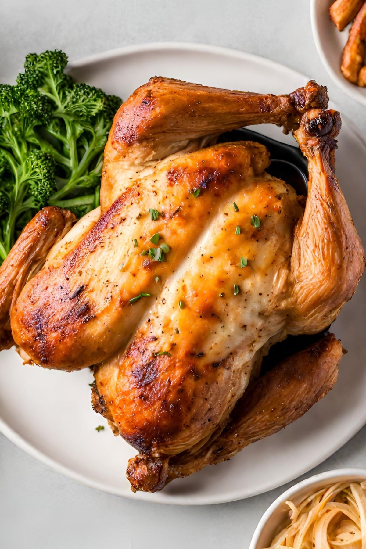 air fryer whole rotisserie chicken on white platter