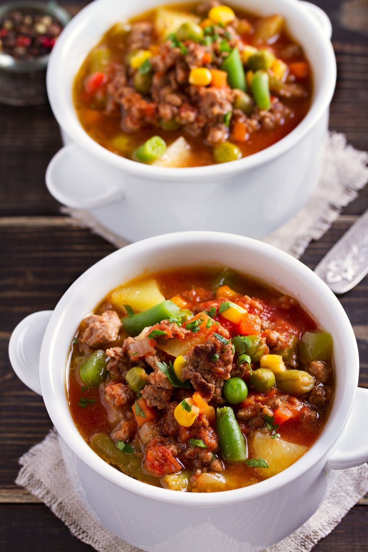 two ramekins of vegetable soup with ground beef