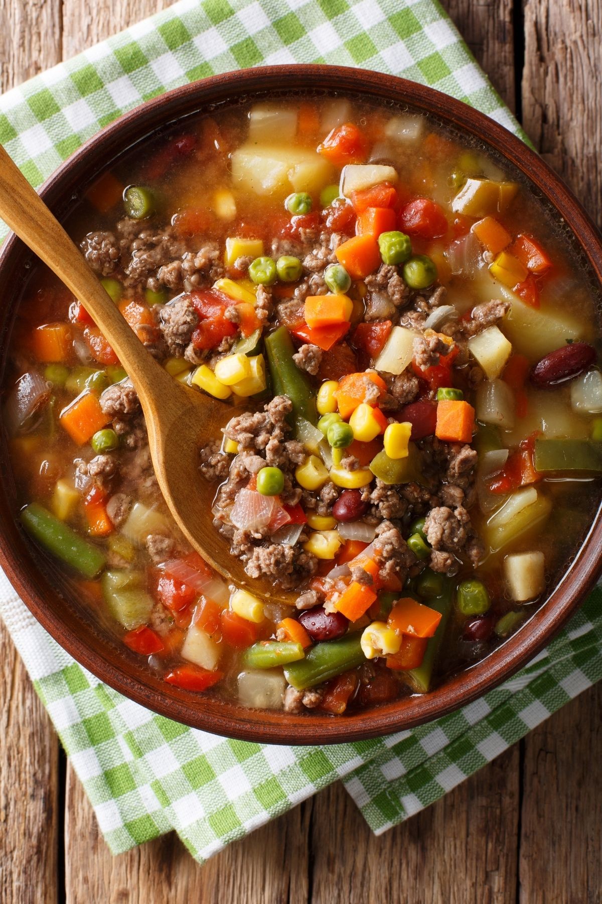 bowl of hamburger vegetable soup with a spoon