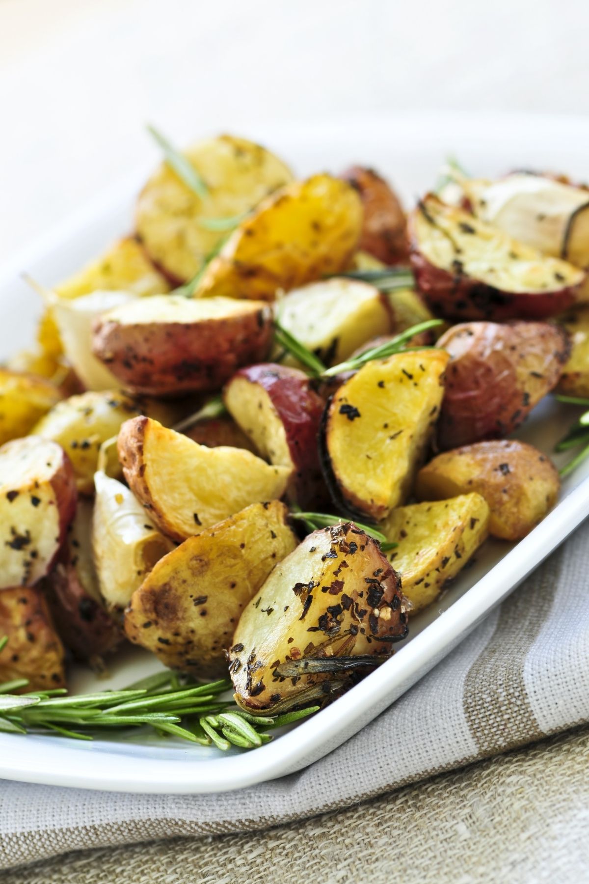 herb roasted potatoes on white platter