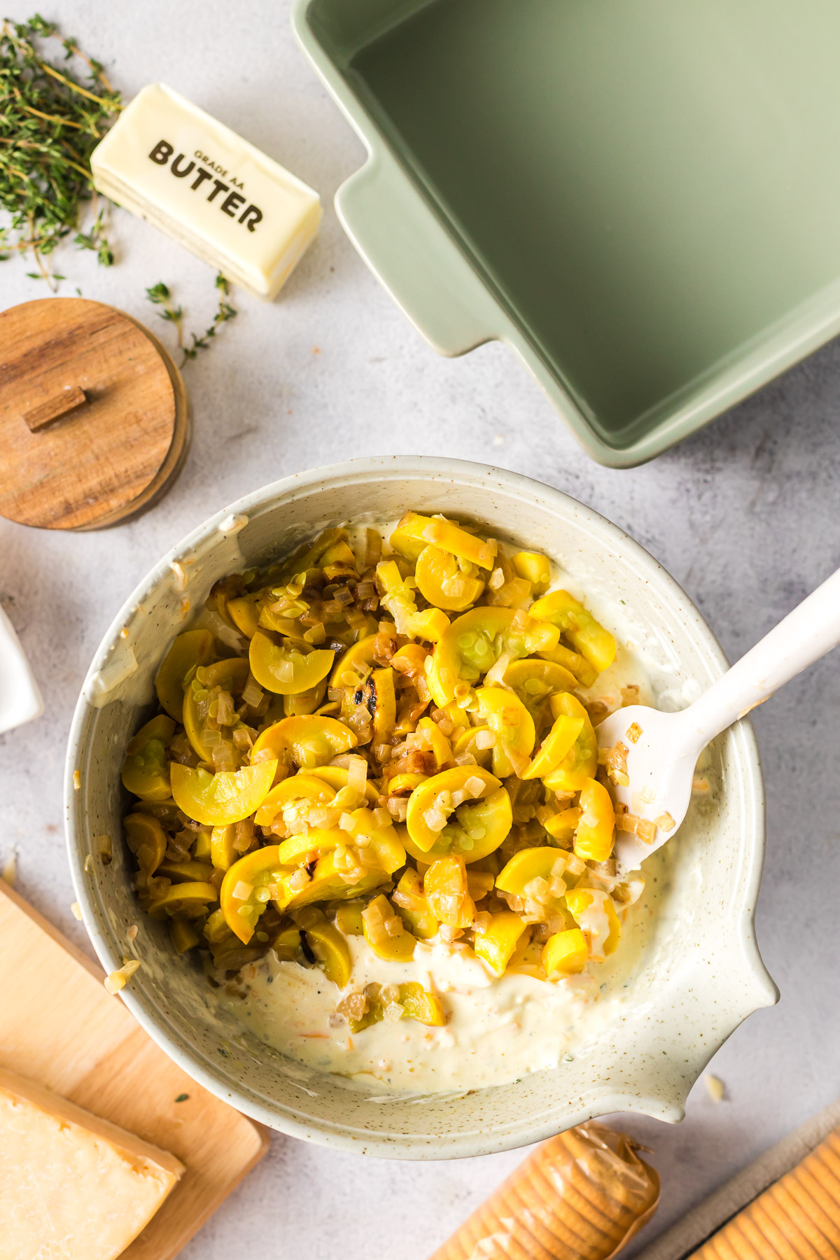 mixing squash and onions into creamy sauce