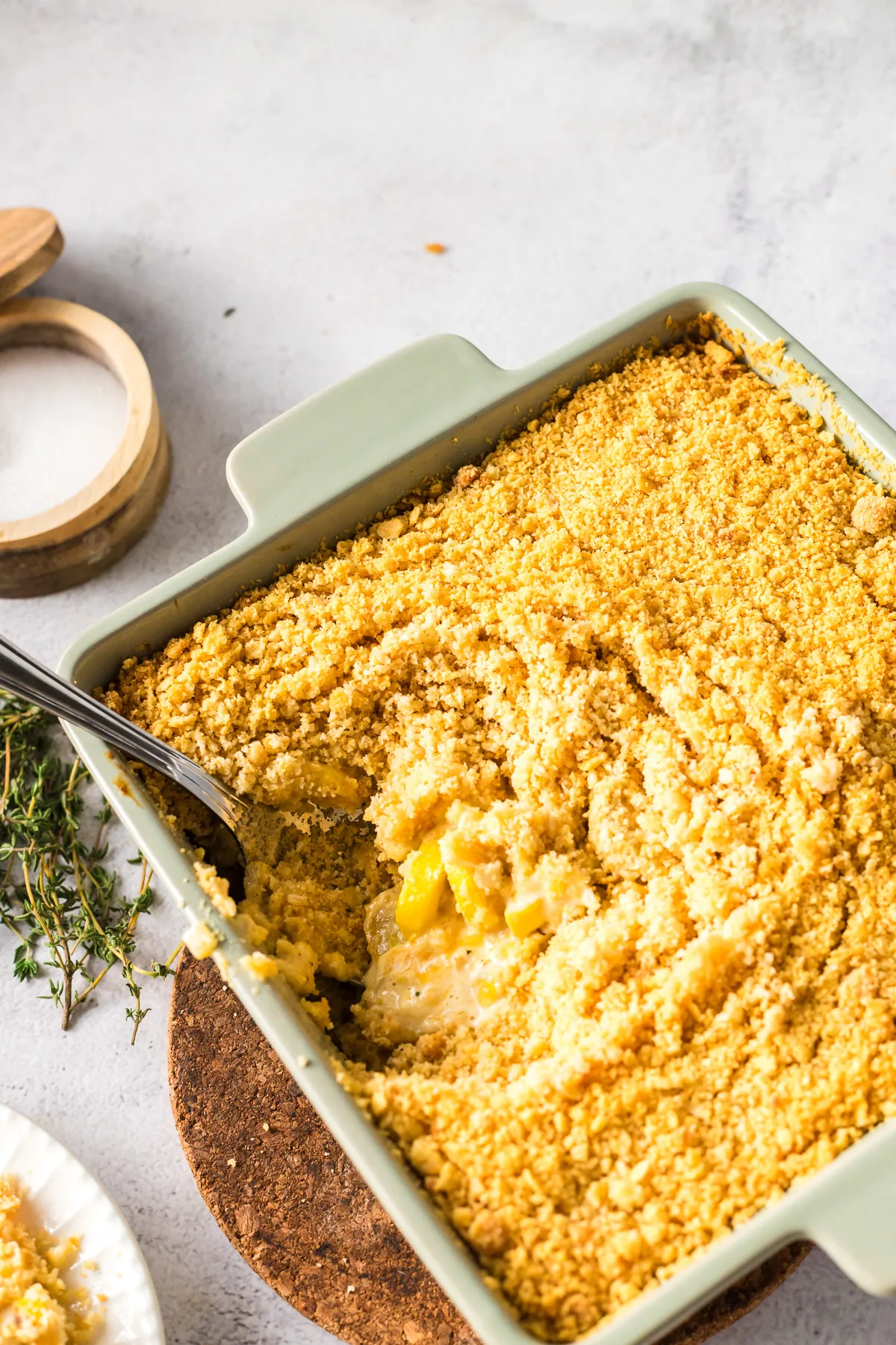 baked squash casserole with serving spoon