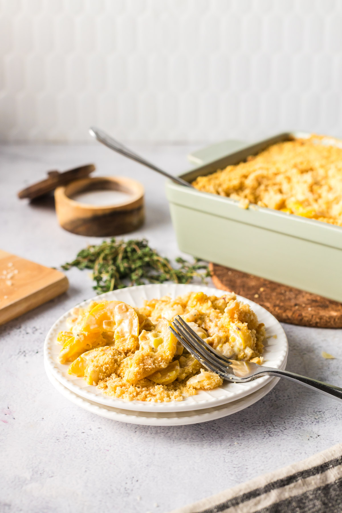 a single serving of squash casserole on a white plate