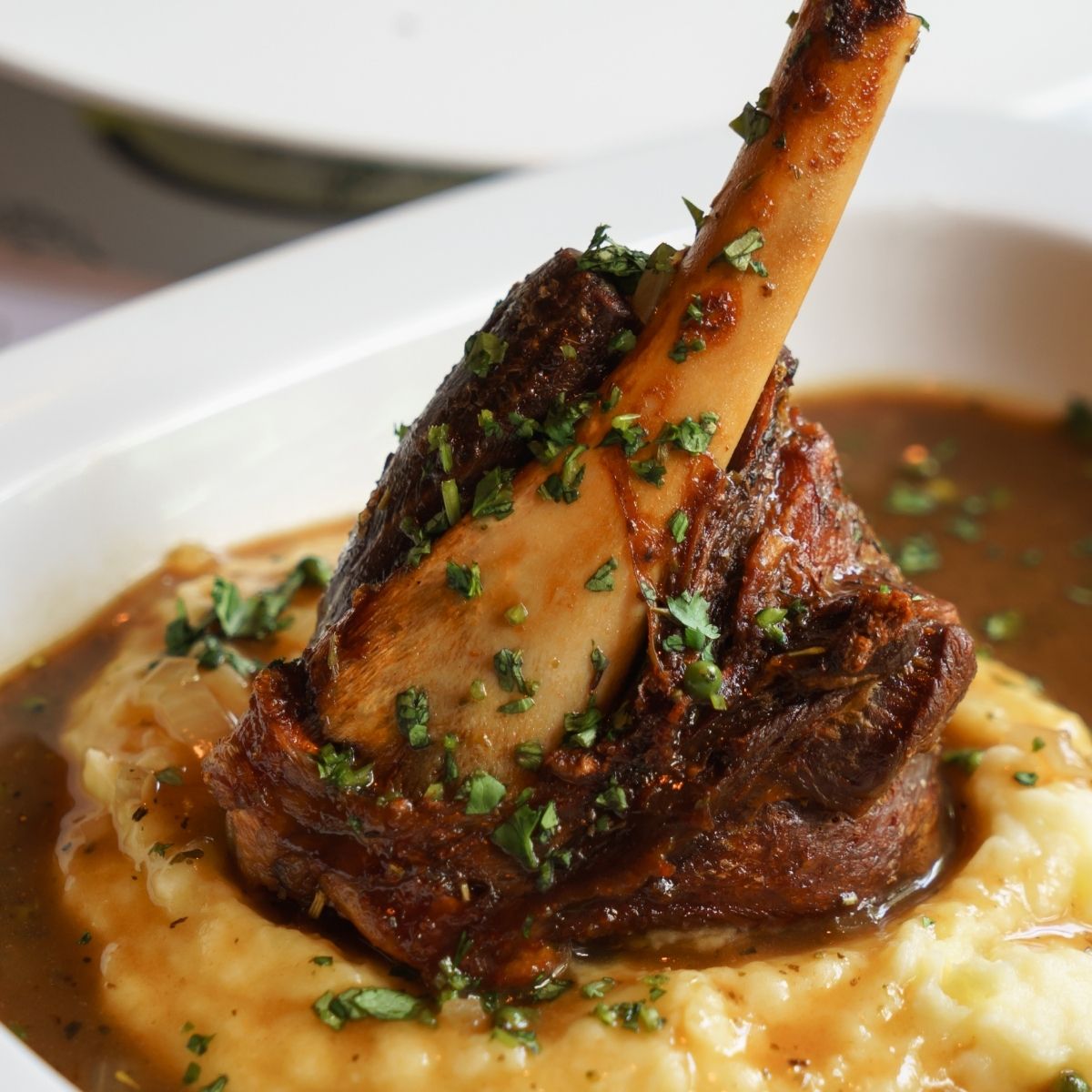 lamb shank over mashed potatoes with dark brown gravy