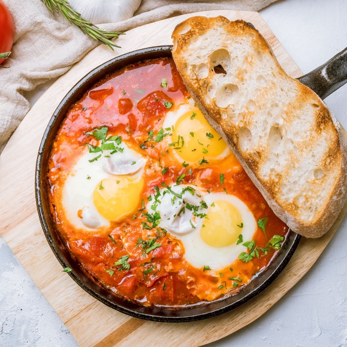 Shakshuka in skillet with bread