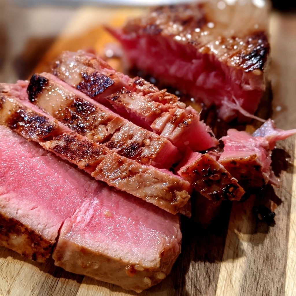 seared and sliced ahi tuna on cutting board