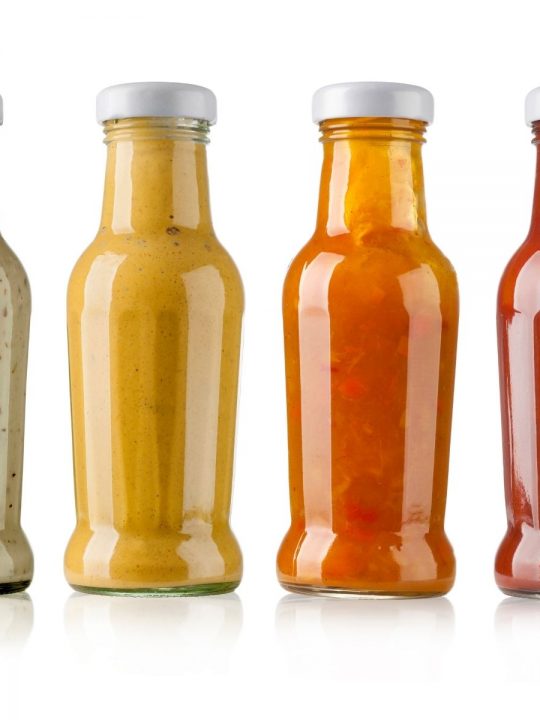 row of different bbq sauces in bottles