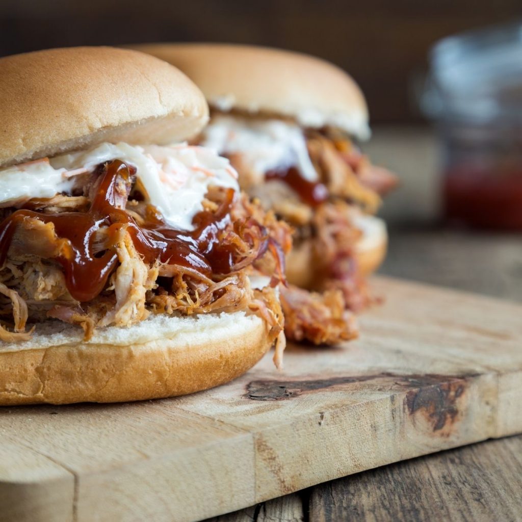 bbq pork sandwich on cutting board