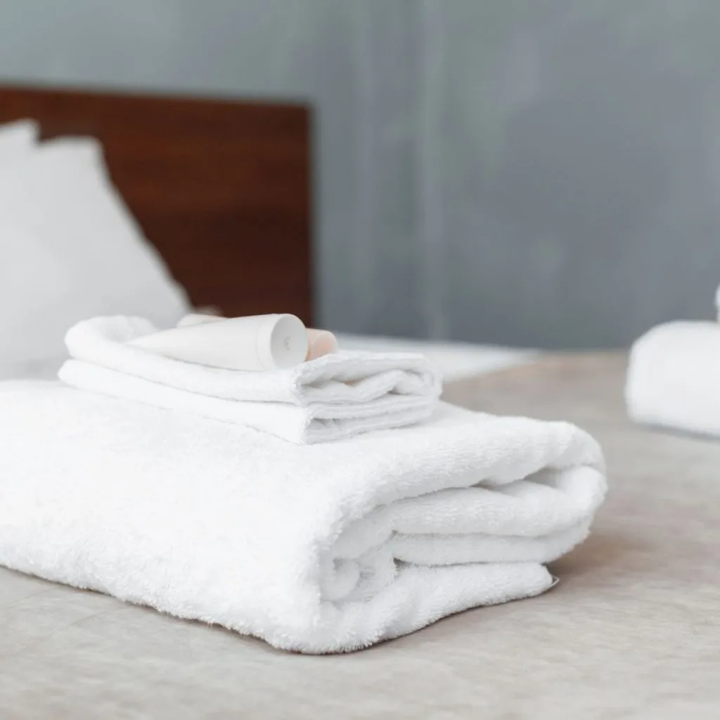 white towels folded on guest bed