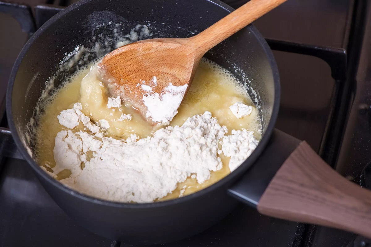 Stirring flour into melted butter on stove