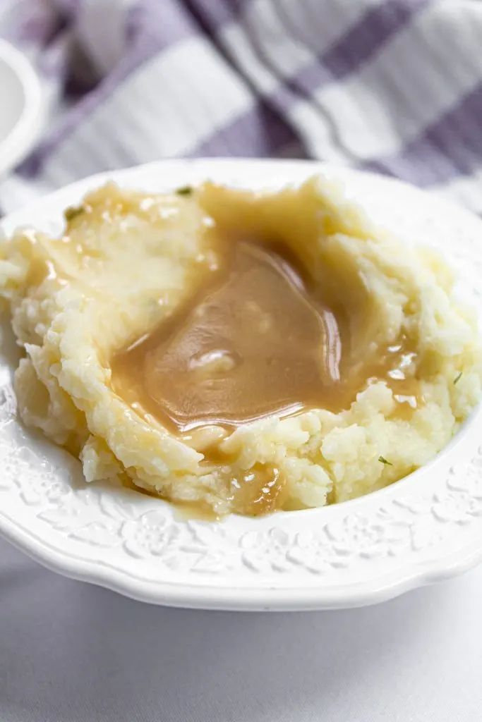 mashed potatoes and gravy in a white bowl