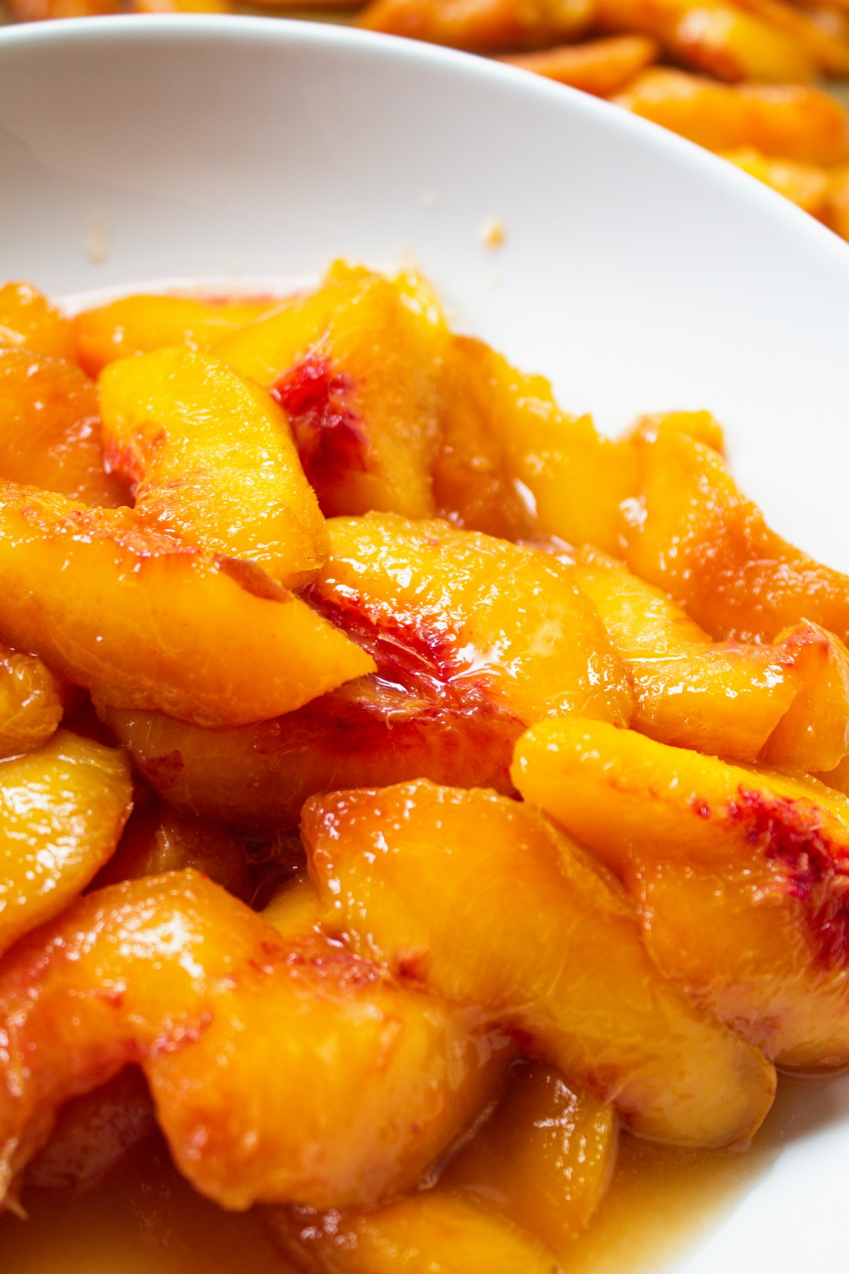 Peeled peaches in a white bowl