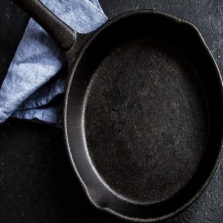 resized image of black cast iron pan with blue towel